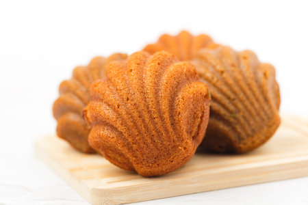 Madeleine cakes with a distinctive shell-like shape on white background for bakery, food and eating...