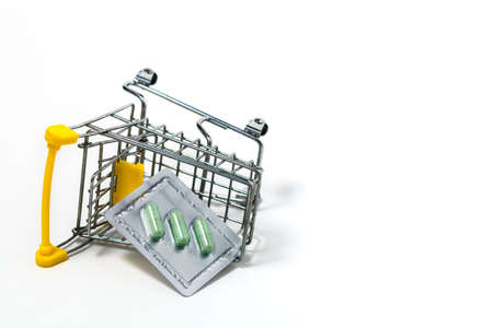 Green chiretta herbal capsule in the shopping cart against white background for healthcare and medical conceptの写真素材