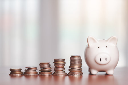 Saving piggy bank with step of money coins on the wooden table for investment, business, finance and saving money concept.の写真素材