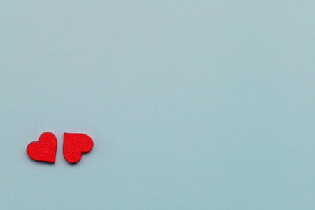 Blue background adorned with red hearts, symbolizing love, valentine, romance, and passion that is a...