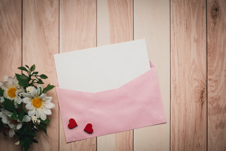 Envelope with blank paper and flowers on wooden background - Vintage Filter