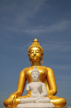 White buddha with golden buddha backgroundの写真素材