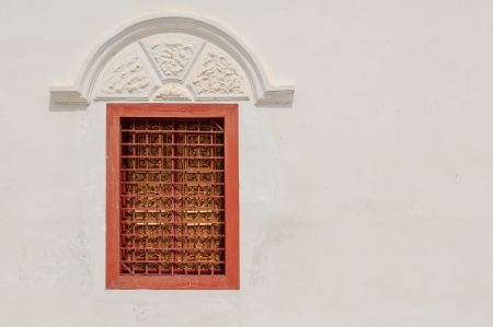 white wall with  closed red windowの写真素材