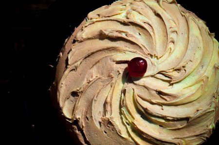 frosted cake with a cherry on top 