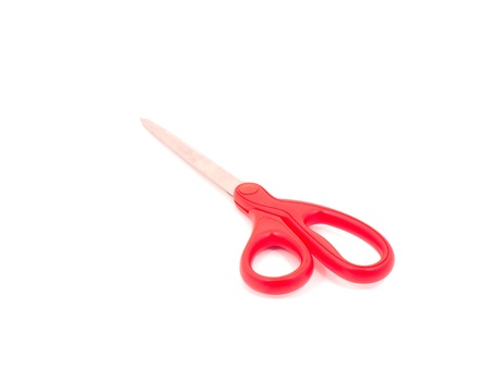 Scissors with red handle on white backgound の写真素材