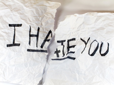 Write I HATE YOU on crumple white paper and tear it の写真素材