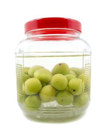 Pickle Japanese plum liqueur in glass jar with rice whiskey and rock sugar isolatedの写真素材