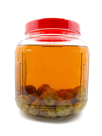 After pickle Japanese plum liqueur in glass jar with rice whiskey and rock sugar isolatedの写真素材