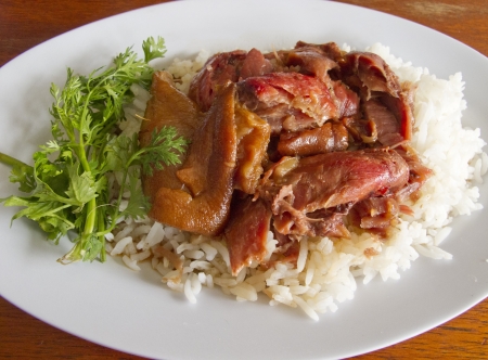 Thai stewed pork leg with rice and parsley  Kao Ka Moo  on white plateの写真素材