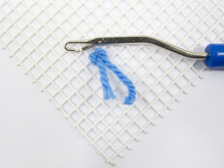Latch Hook Rug stitch with canvas and yarnの写真素材