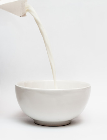 Pouring milk into a bowlの写真素材