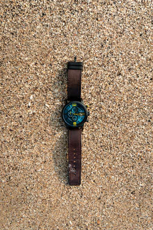 Image of Man wrist watch on sand of beach captured on 29/12/2020 while travelling Ganapati pule beach located at Ratnagiri district, Maharashtra state,India.のeditorial素材