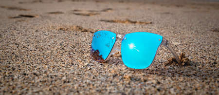 Blue sunglass on beach sand Beach
