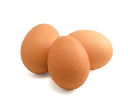 Three brown eggs isolated on whiteの写真素材