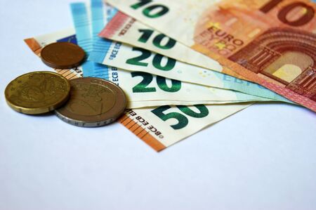 Euro banknotes and coins. Selected focus, narrow depth of field.