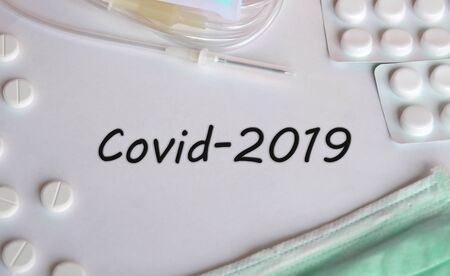 Covid-2019 virus concept. Various medicines: tablets, ampoules, mask.の写真素材