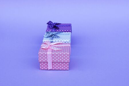 Three gifts on a lilac background.