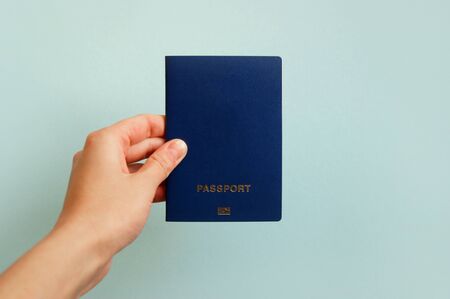 Biometric international passport in a female hand. Travel conceptの写真素材