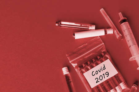 Covid-2019 virus concept. Syringe and ampoules with a vaccine against the virus.の写真素材
