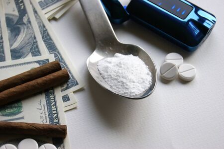 Drugs, cigars and money on a white background. Addiction concept