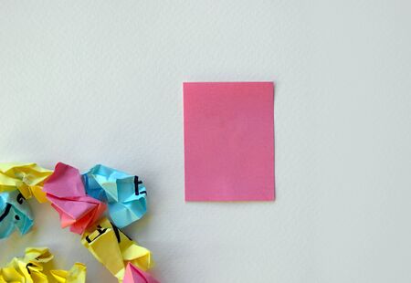 Blank pink sticker for inscription. Crumpled stickers are scattered around. White background, design...