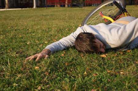 Man fell off the bike in the park.の写真素材