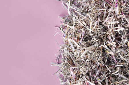 Shredded paper on light pink background. Selective focus image.の写真素材