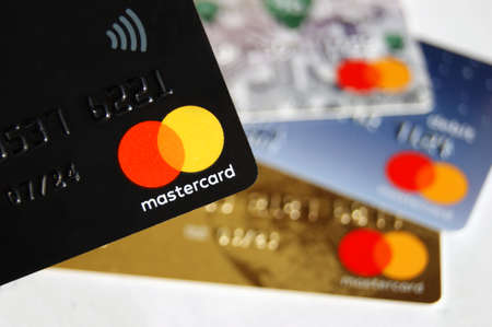 KHARKOV, UKRAINE - FEBRUARY 8, 2020: Close up of a Master Card Credit Card on white background. Against the background of three more bank cards.のeditorial素材