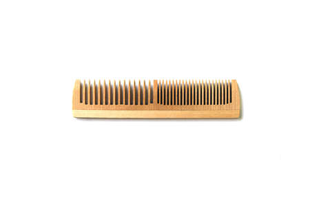 Single wood comb isolated on white background. Hair care concept.
