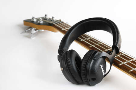 KHARKOV, UKRAINE - APRIL 6, 2020: Marshall bluetooth headphones, wireless, and fretboard from bass...