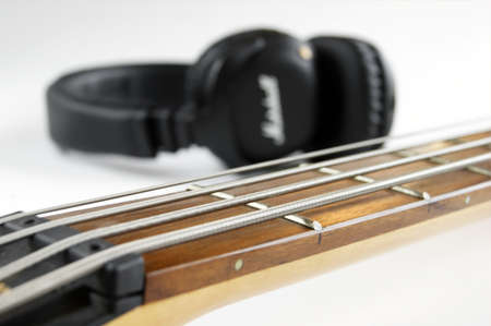 KHARKOV, UKRAINE - APRIL 6, 2020: Marshall bluetooth headphones, wireless, and fretboard from bass...