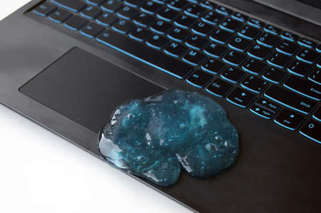 Blue soft gel cleaning dust on keyboard. Concept cleaning your computer's keyboard. Office cleaning.