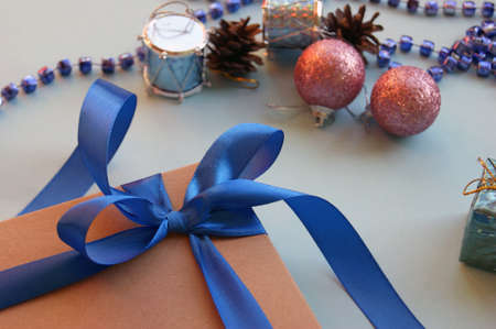 Christmas gift craft box on a blue background with decoration. Happy new year background