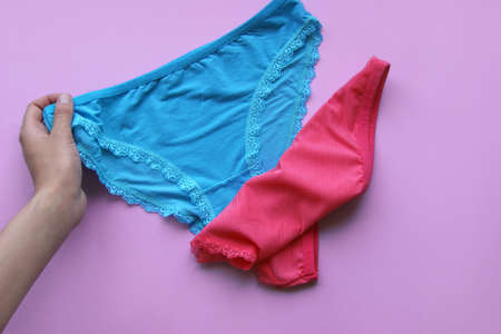 Set of women's panties on a pink background. Pink and blue underwear.の写真素材