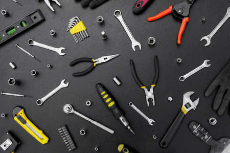 Many different tools for repair work on a black background. Repair and construction concept.の写真素材