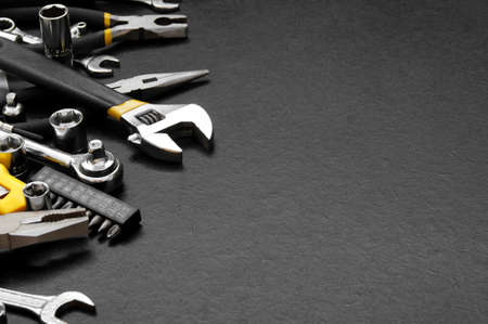 Many different tools for repair work on a black background with copy space for text. Repair and...