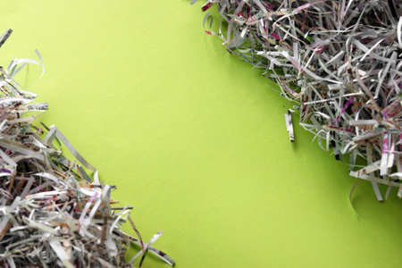 Shredded paper on light green background.