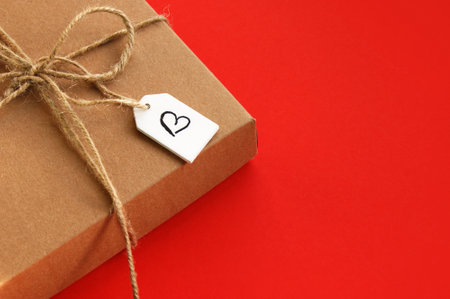 Kraft Gift box with wood tag and painted heart , concept of Valentines, anniversary. Top view