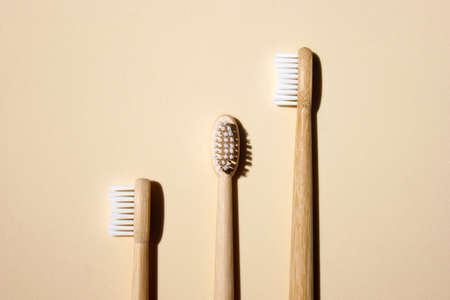 Bamboo toothbrushes on light background. Say no to plastic concept. Top view, copy space, flatlay.