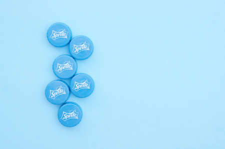 KHARKIV, UKRAINE - JUNE 14, 2020: Many of blue Sprite drink caps on a blue background.のeditorial素材