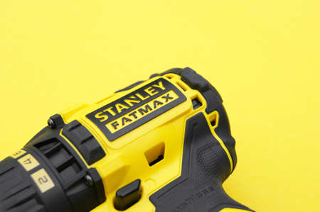KHARKIV, UKRAINE - JUNE 14, 2020: Stanley's new cordless screwdriver on a yellow background.