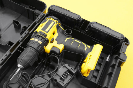 The yellow-black screwdriver on a yellow background, a set of bits.
