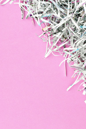 Shredded paper on light pink background. Selective focus image.の写真素材