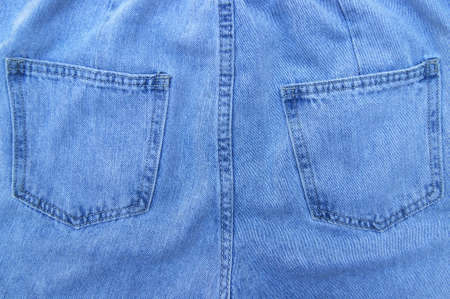 Flat lay, denim jeans leg seam detail, background texture. Copy space.