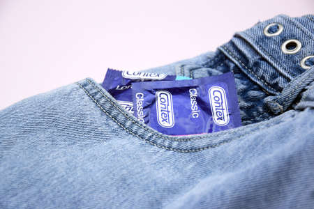 KHARKIV, UKRAINE - OCTOBER 16, 2021: Contex condom in jeans pocket. Contex is a brand of condoms and...