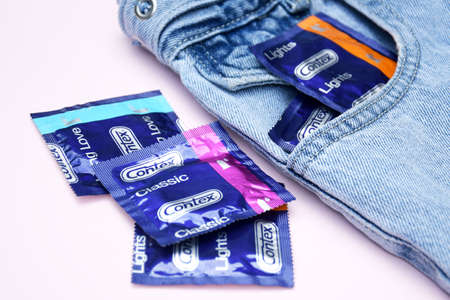 KHARKIV, UKRAINE - OCTOBER 16, 2021: Contex condom in jeans pocket. Contex is a brand of condoms and personal lubricants owned by Reckitt Benckiser. Sexual protection concept.のeditorial素材