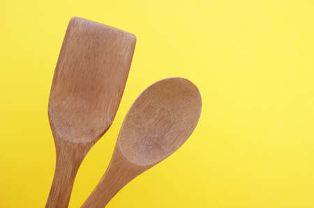 A set of bamboo dishes on a bright yellow background. Cooking concept.の写真素材