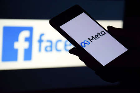 Smartphone with Meta on the background on of products owned by facebook metaverse.のeditorial素材