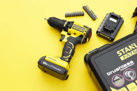 KHARKIV, UKRAINE - JUNE 14, 2020: Stanley's new cordless screwdriver on a yellow background.のeditorial素材