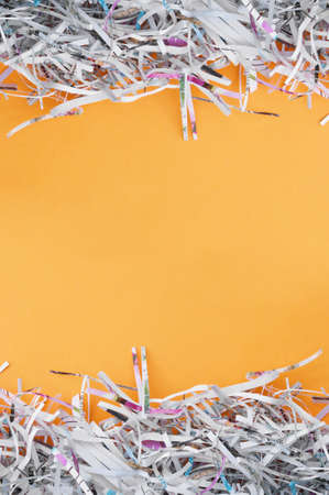 Shredded paper on light orange background. Selective focus image.の写真素材